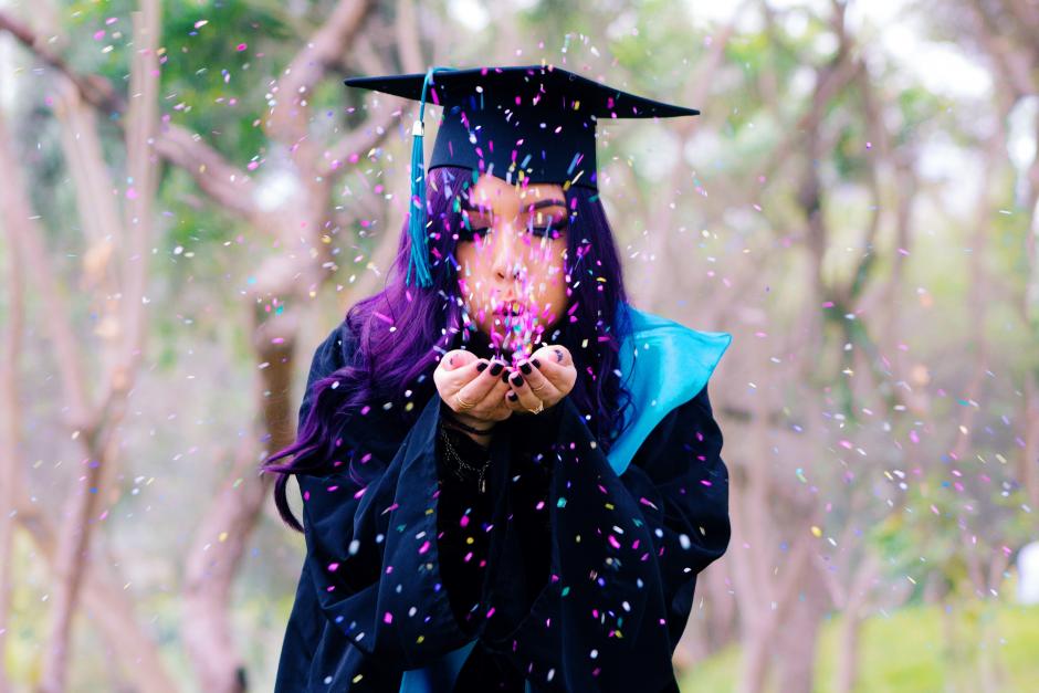 Graduating  Student girl blowing confetti