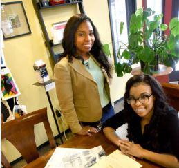 Akosia Robinson and daughter Sefani sitting at desk